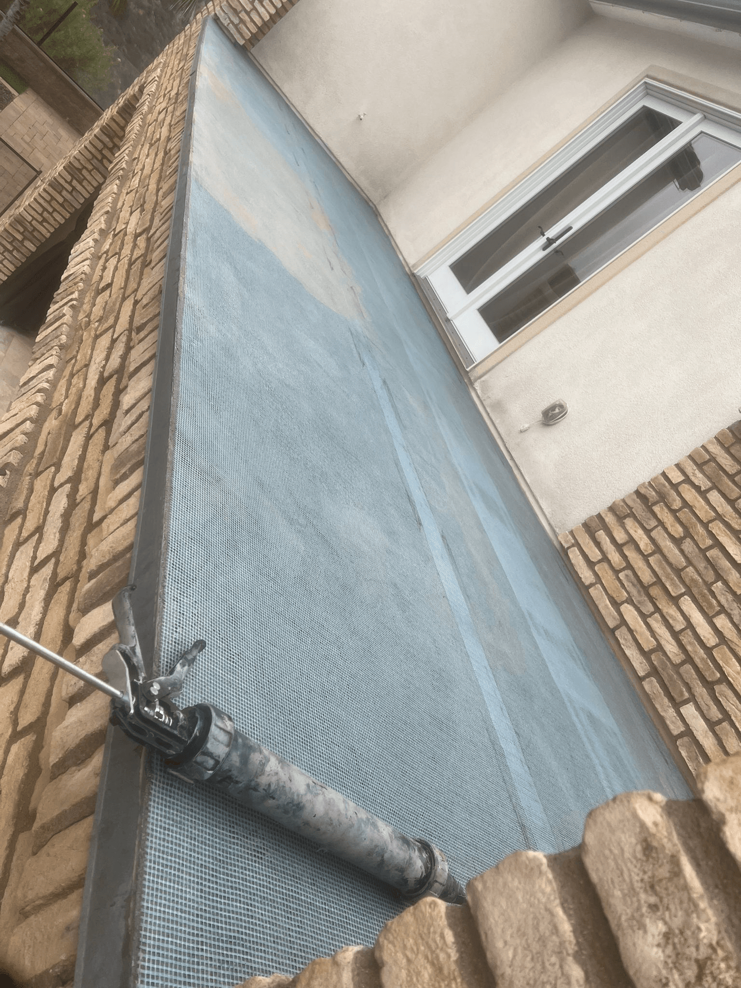 Stucco mesh and base coat repair on exterior wall